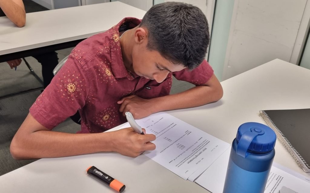 Student completing an assessment worksheet at NRICH Learning