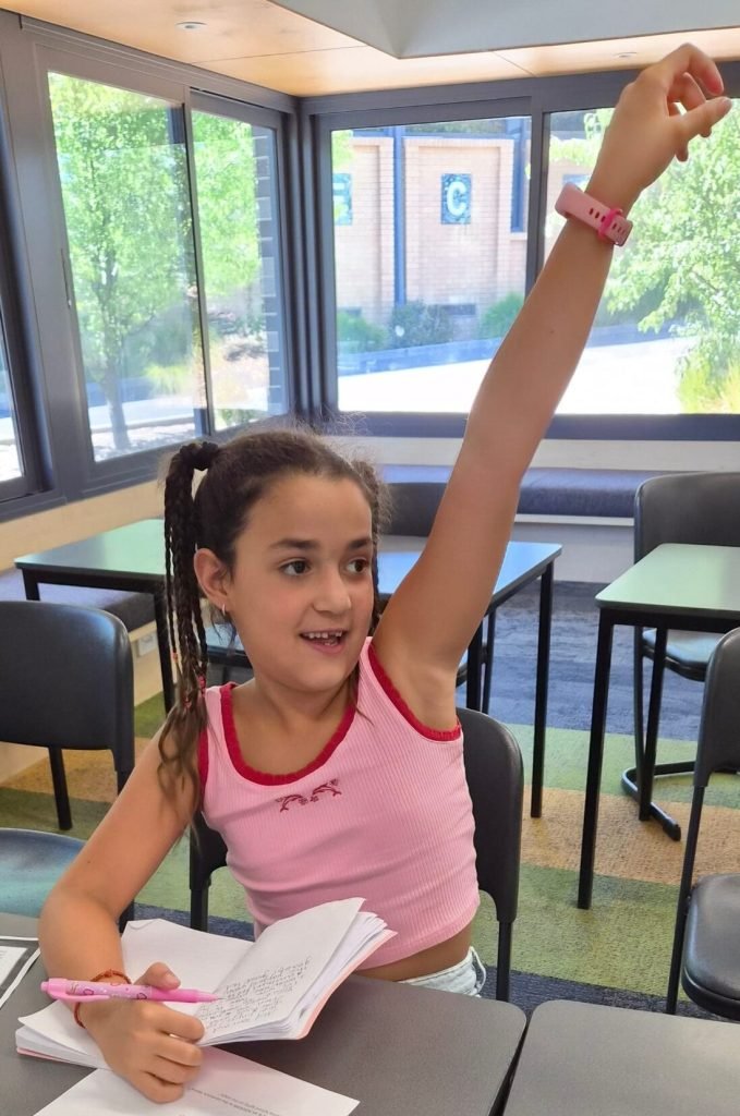 Student raising her hand during a NRICH Learning lesson