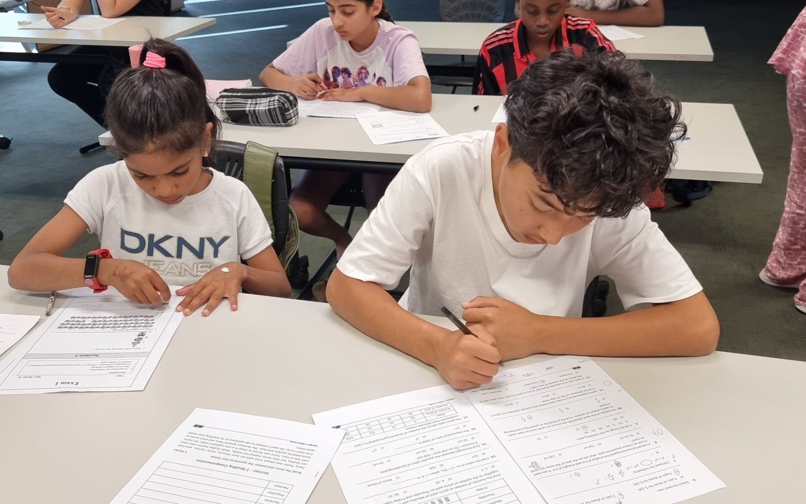 Students writing answers during a NRICH Learning class