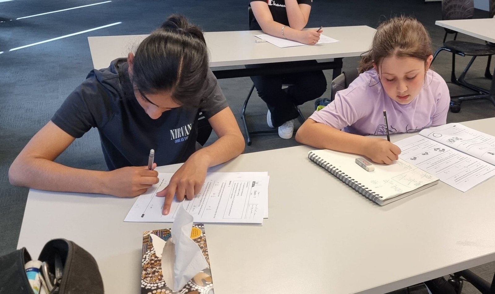 Students completing worksheet practice at NRICH Learning